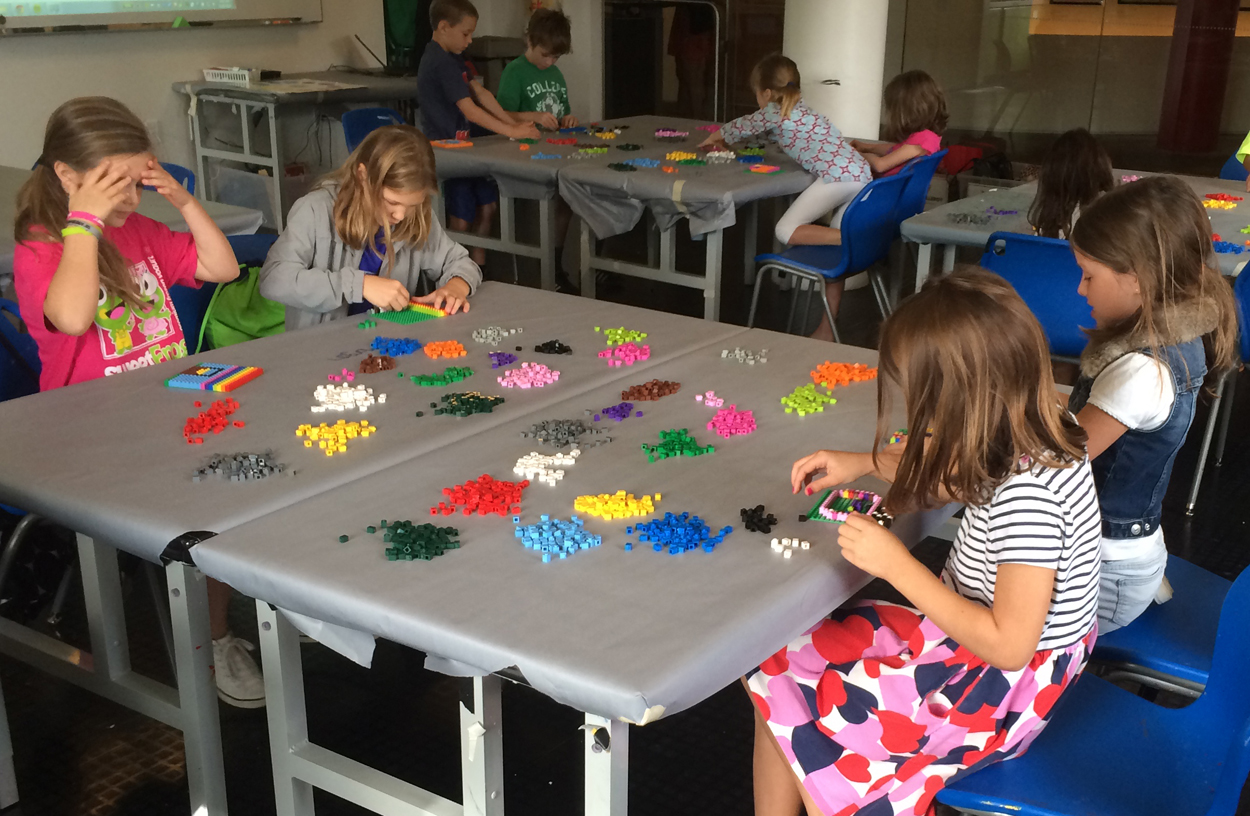 Kids building LEGO mosaics